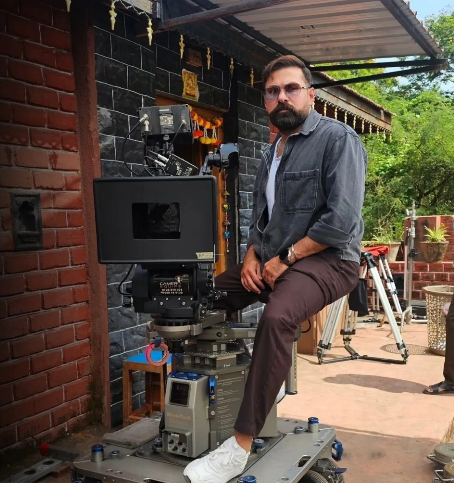 Hassan Elzein on set beside a cinema camera
